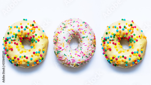 Donuts with bright sprinkles on a white background, food concept, 16:9 © Анастасия Семашко