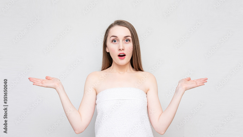 Funny girl shows palms free space for advertising, empty space, portrait, white background, 16:9 Funny girl shows palms free space for advertising, empty space, portrait, white background, 16:9