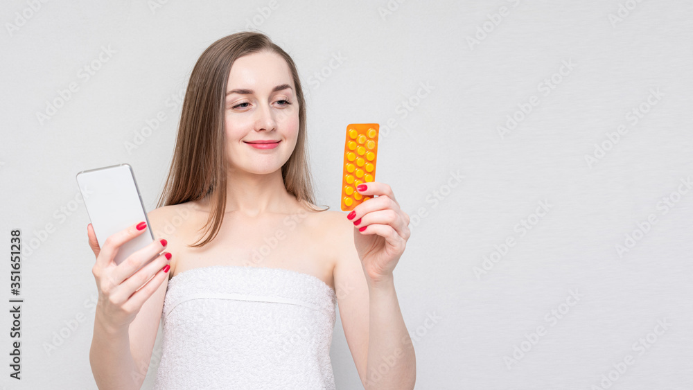 Woman with control pills and phone, white background, Concept of birth control pills, 16:9 Woman with control pills and phone, white background, Concept of birth control pills, 16:9