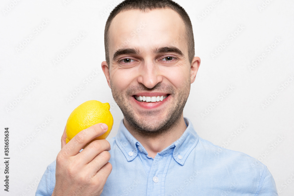 Person with lemon, portrait, white background Person with lemon, portrait, white background