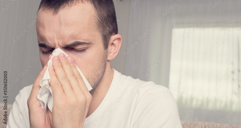 Man got the flu, blew his nose, blocked nose, person is at home on sick leave, close up, 16:9 Man got the flu, blew his nose, blocked nose, person is at home on sick leave, close up, 16:9
