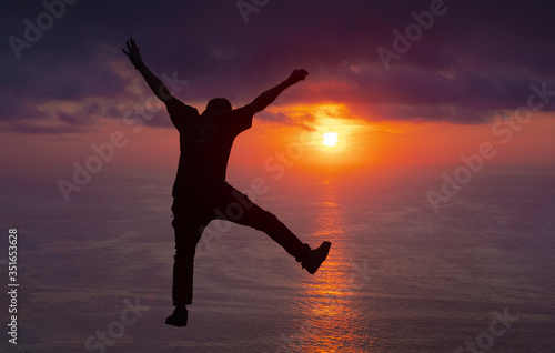 man jumping on the beach