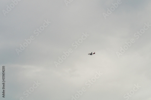 Airplane flying in a cloudy sky