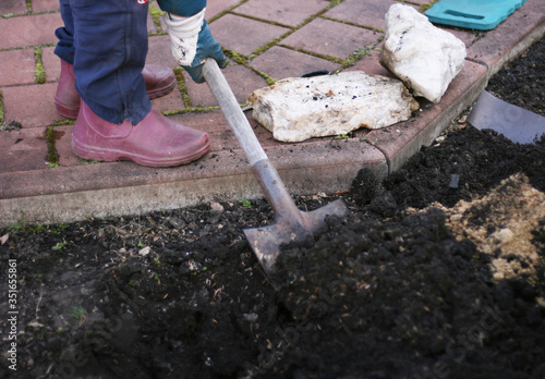 Person diggin ground in a garden. Agriculture consept. Preparation garden for sring or fall photo