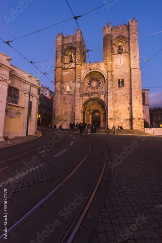 Lisbon, Portugal, January 24, 2020: SE Cathedral in the blue hour with tram rails in the foreground