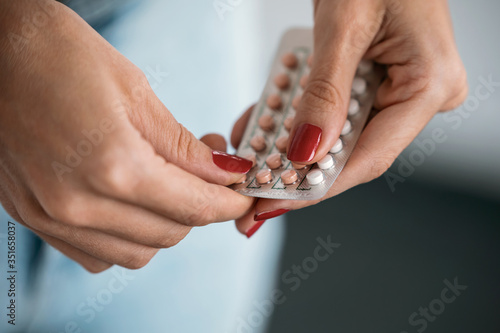 Bild auf Leinwand Woman holding a contraceptive pills