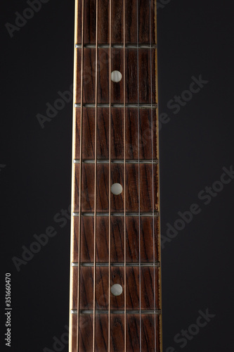 Acoustic classical guitar close-up shot with strings, Close up photo of a beautiful black acoustic guitar on a warm
