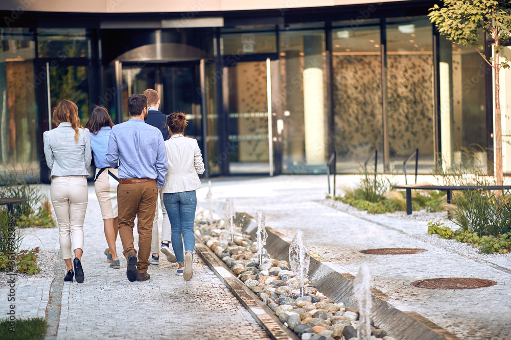 group of young employees entering the business building group of young employees entering the business building