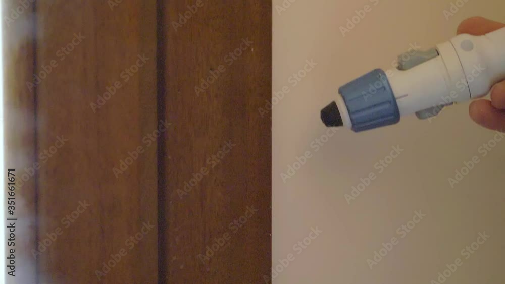 cleaning after painting - worker using the steam cleaner along the door frame cleaning after painting - worker using the steam cleaner along the door frame