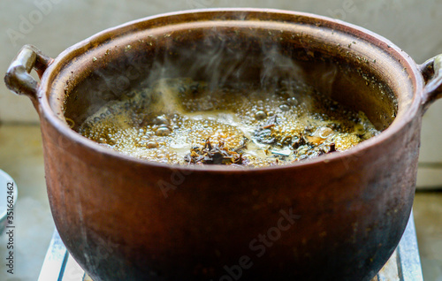 Cooking Chinese herbal medicine soup in clay pot