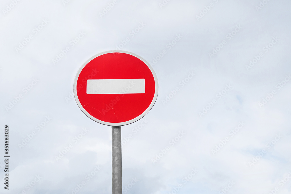 International traffic sign 'No Entry' or 'No Entrance' on white cloudy sky background International traffic sign 'No Entry' or 'No Entrance' on white cloudy sky background
