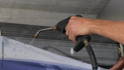 technicial worker use pressure pump gun for clean air condition