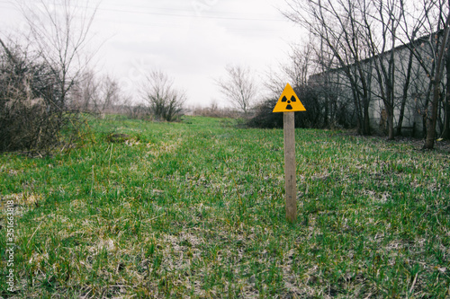 A yellow sign of radiation is visible in the green field