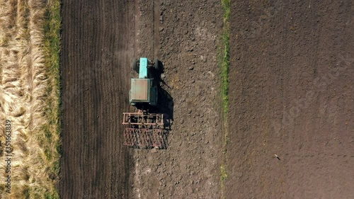 top view, aerial view. the tractor cultivates the land. preparation for growing crops. agriculture in the village and in the countryside.