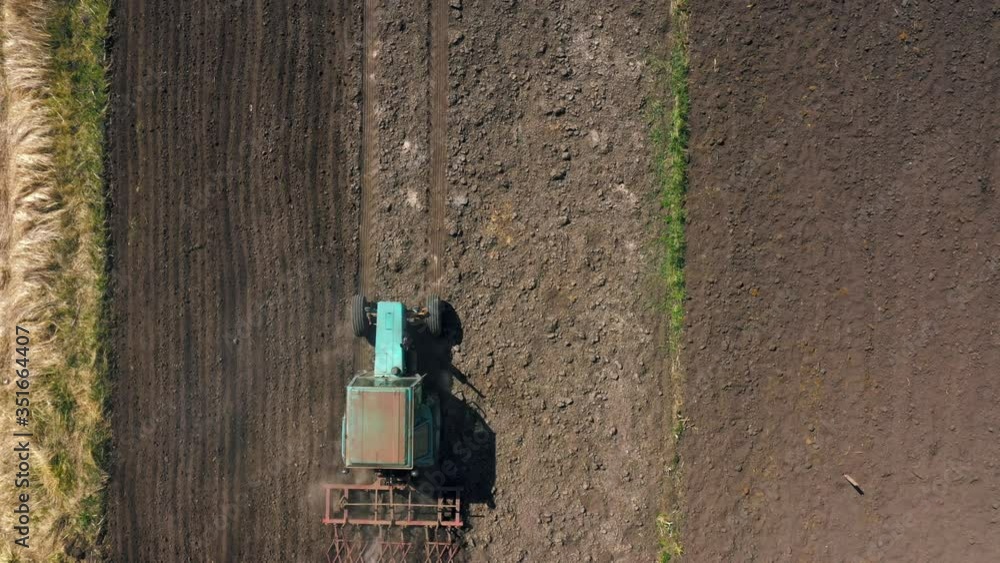 top view, aerial view. the tractor cultivates the land. preparation for growing crops. agriculture in the village and in the countryside. top view, aerial view. the tractor cultivates the land. preparation for growing crops. agriculture in the village and in the countryside.