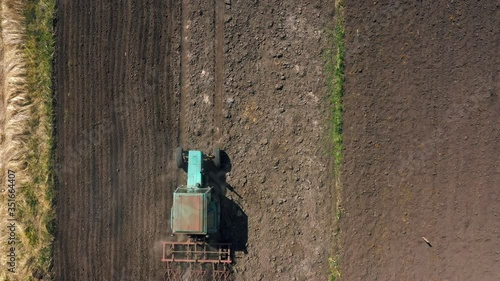 top view, aerial view. the tractor cultivates the land. preparation for growing crops. agriculture in the village and in the countryside.