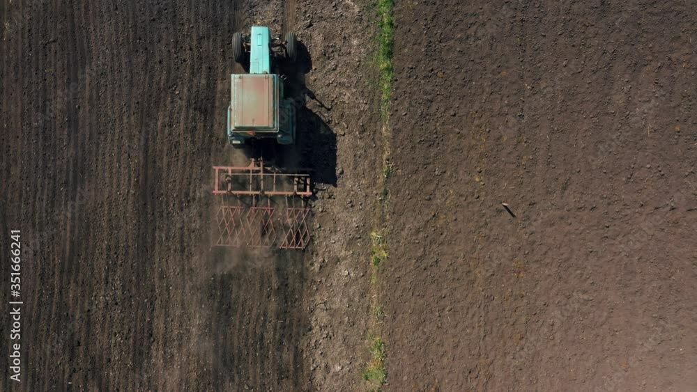 top view, aerial view. the tractor cultivates the land. preparation for growing crops. agriculture in the village and in the countryside. top view, aerial view. the tractor cultivates the land. preparation for growing crops. agriculture in the village and in the countryside.
