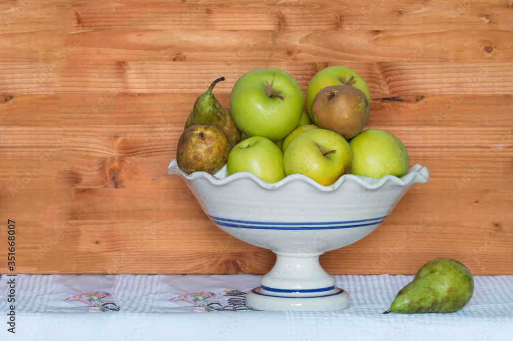 ceramic fruit bowl with apples and pears on cloth and wood tablecloth ceramic fruit bowl with apples and pears on cloth and wood tablecloth