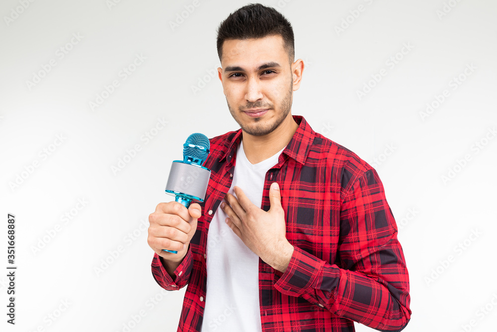 male presenter with a microphone in his hands has a sore throat on a white isolated studio background male presenter with a microphone in his hands has a sore throat on a white isolated studio background