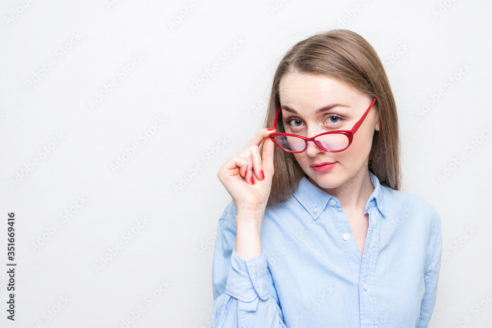 Playful secretary woman took off red glasses, portrait, white background, copy space Playful secretary woman took off red glasses, portrait, white background, copy space