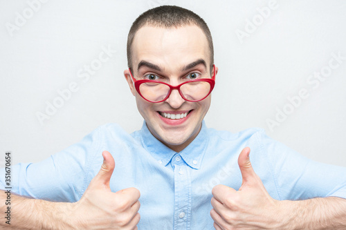 Funny nerd shows sign super with fingers  man with glasses  portrait  white background
