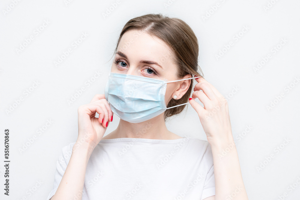 Doctor or nurse wears a medical mask, portrait, close-up, white background Doctor or nurse wears a medical mask, portrait, close-up, white background