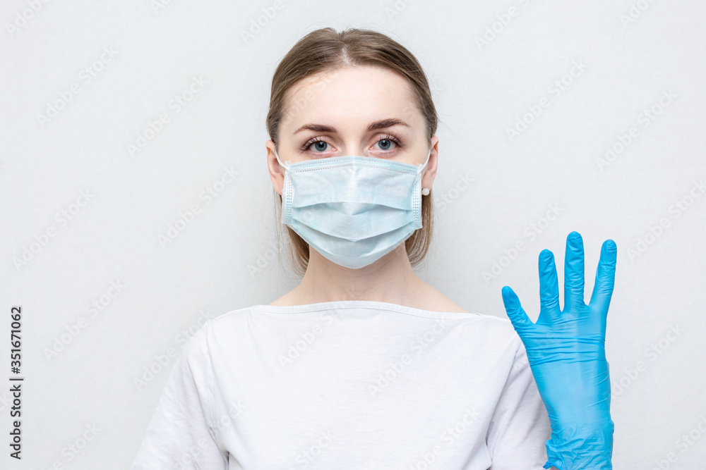 Doctor or nurse in medical mask and gloves show sign four, portrait, close up Doctor or nurse in medical mask and gloves show sign four, portrait, close up