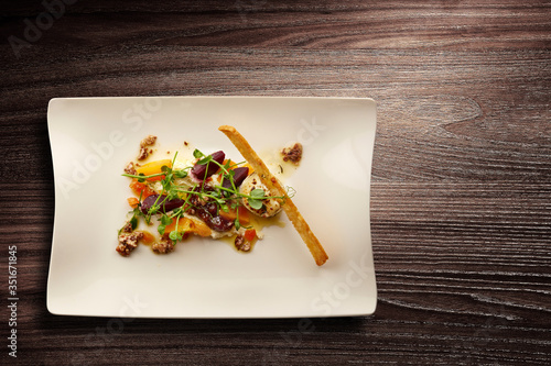 Stylish Nouvelle cuisine plate of beetroot and walnut salad