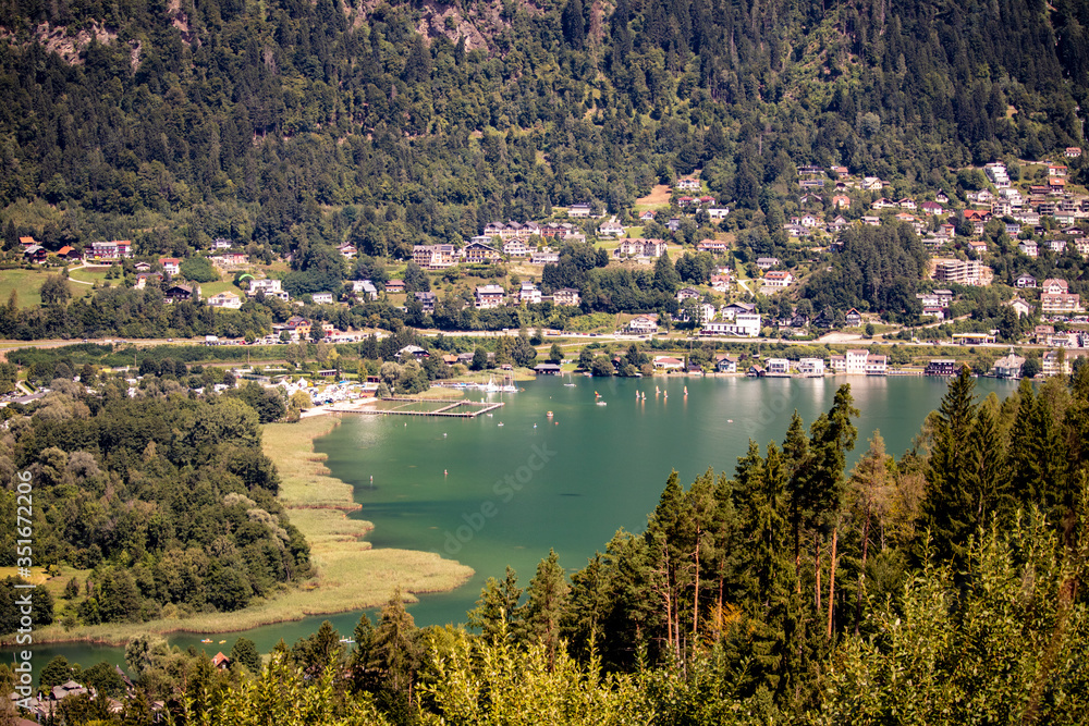 Panorama from Ossiacher lake with the mountain Gerlitzen in the background in sunny weather in Carinthia, Austria in Europe