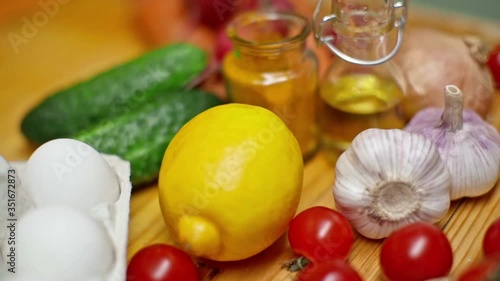 Toasts and mashed avocado with A variety of fresh summer products on the table in slow motion. Cooking a delicious healthy vegetarian breakfast. Healthy eating and healthy lifestyle.