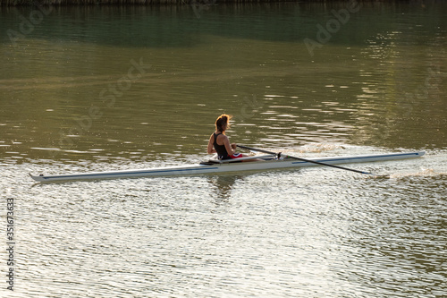 Photography A young female athlete is rowing in a single scull on the Danube, Budapest Hunga