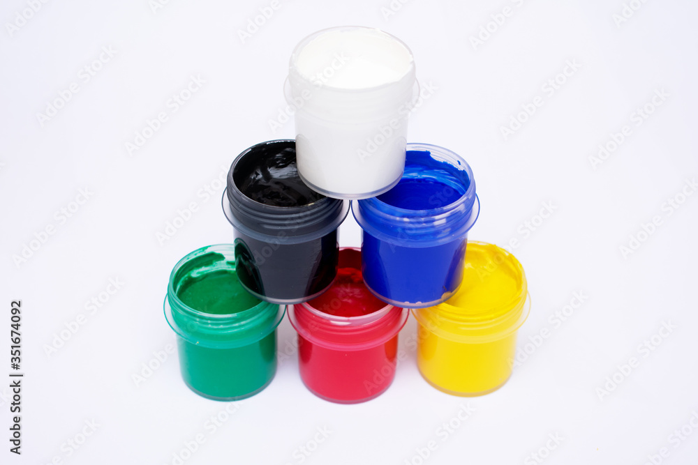 Cans of different colors gouache paints, top view, closeup, white background Cans of different colors gouache paints, top view, closeup, white background