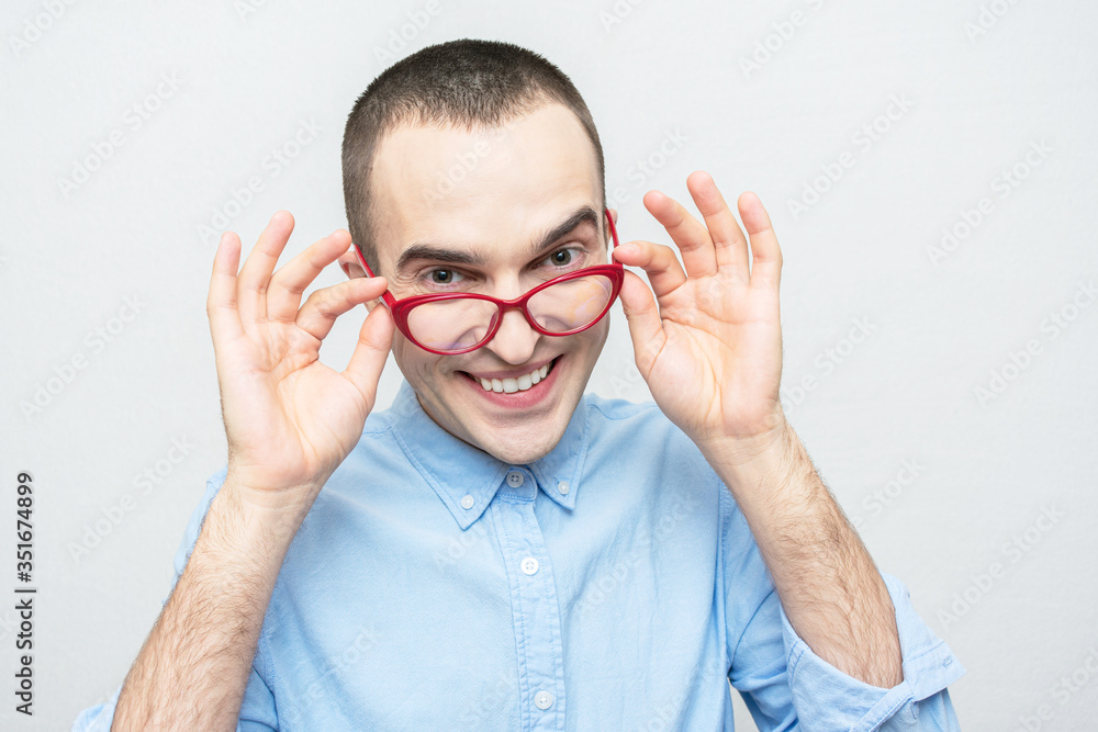 Funny nerd man took off red glasses, portrait, white background Funny nerd man took off red glasses, portrait, white background