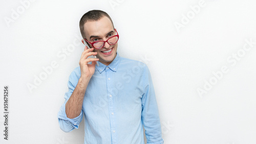 Guy's on the phone. Portrait of nerd man in red glasses, white background, copy space, 16:9