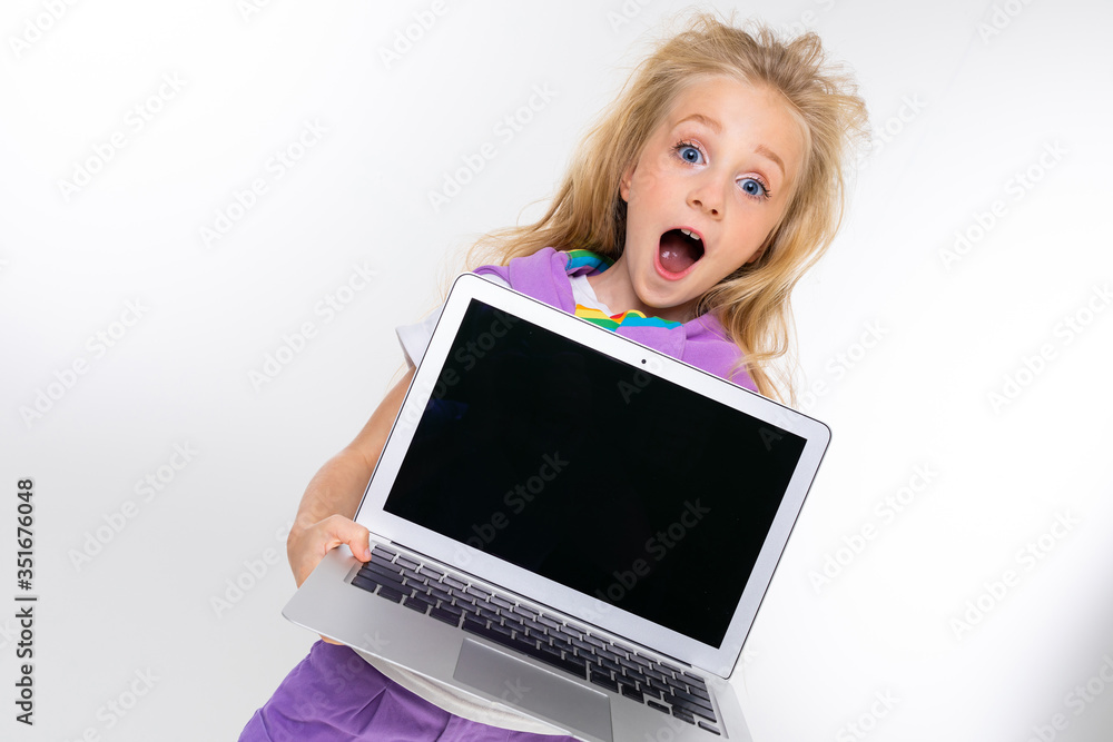 Sports teenager girl in sport suit holds a tablet with keyboard isolated on background Sports teenager girl in sport suit holds a tablet with keyboard isolated on background
