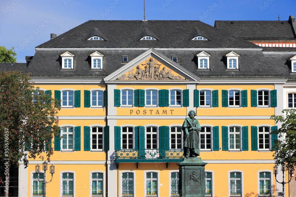 Fototapeta premium Monument of Ludwig van Beethoven - with the Old Post Office building in the background. Bonn, Germany.
