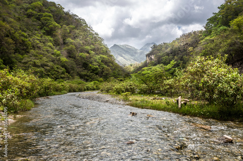 dramatic image of river and rocks at rio Ocoa, dominican republic high in the caribbean mountains.