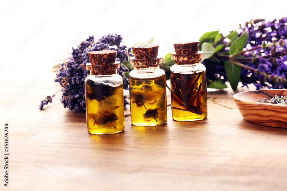 lavender herbal oil and lavender flowers. bottle of lavender massage oil for aromatherapy treatment lavender herbal oil and lavender flowers. bottle of lavender massage oil for aromatherapy treatment