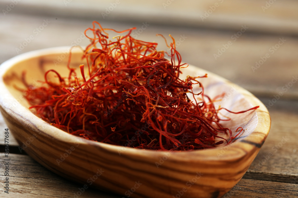 Fototapeta premium Kesar, Saffron, Crocus Sativus on rustic table, Pile of indian Saffron