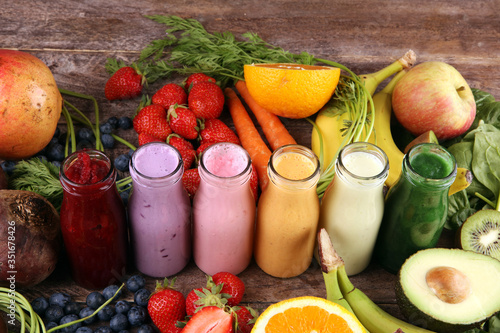 Multicolored smoothies and juices from vegetables, greens, fruits and berries, food background. Detox and dieting, clean eating, healthy lifestyle concept