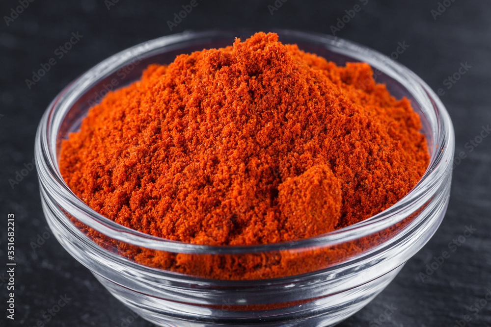 aromatic ground paprika on a dark stone background aromatic ground paprika on a dark stone background