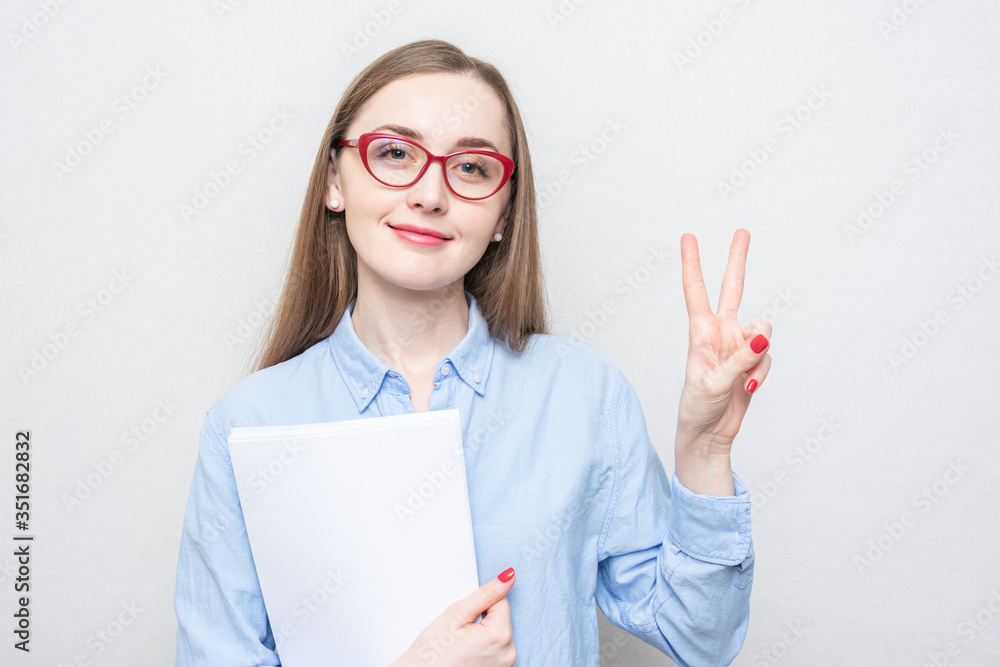 Cute teacher in red glasses shows peace, portrait, white background Cute teacher in red glasses shows peace, portrait, white background