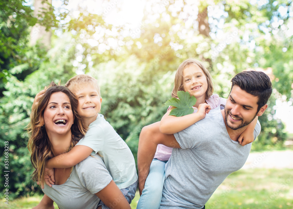 family having fun in the park together in summer family having fun in the park together in summer