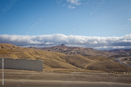 desert-mountainous terrain . Blue sky with many white clouds. Desert and Mountain Landscape with Azerbaijan . Desert and blue sky with white clouds. Big yellow sand, desert and blue sky. Nature .