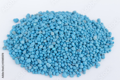 Blue chemical fertilizer on white background.