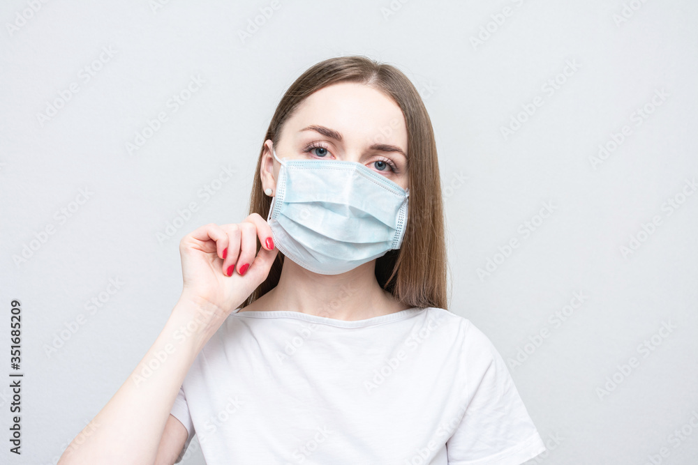 Pretty girl wears a medical mask, portrait, close up, white background Pretty girl wears a medical mask, portrait, close up, white background