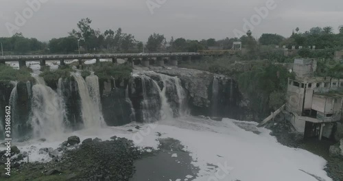 Mexico Rio Lerma Aeria shot. Drone flight over the waterfall of the river Lerma. Polluted river, water falls to the bottom, polluted water, killer river, white foam, water with chemicals, save nature.