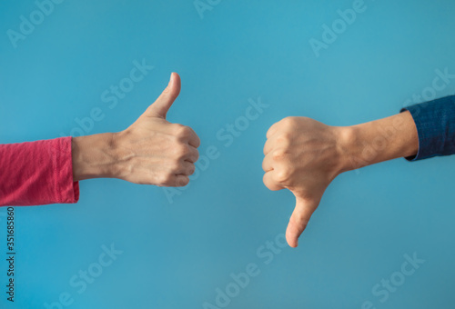 Fotografie Thumbs up thumbs down. Yes or no choice.