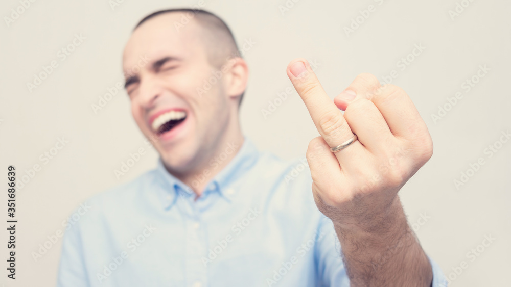 Joyful man shows off his wedding ring, focus on hand, white background, 16:9 Joyful man shows off his wedding ring, focus on hand, white background, 16:9
