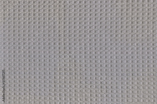 The texture of the cotton towel is rough grey. Abstract background of natural rough canvas.